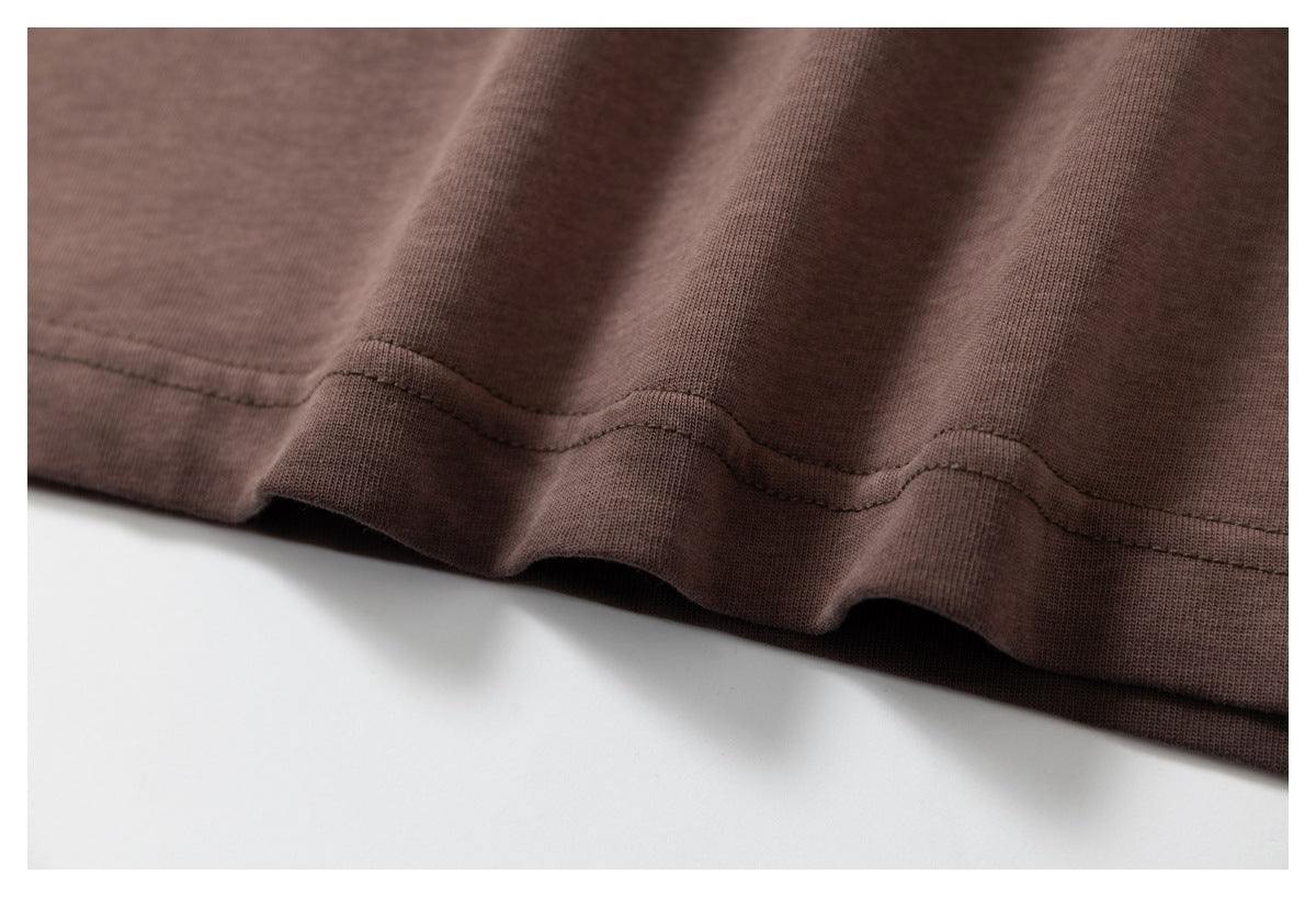 Close-up of the dark brown T-shirt’s bottom hem and stitching.