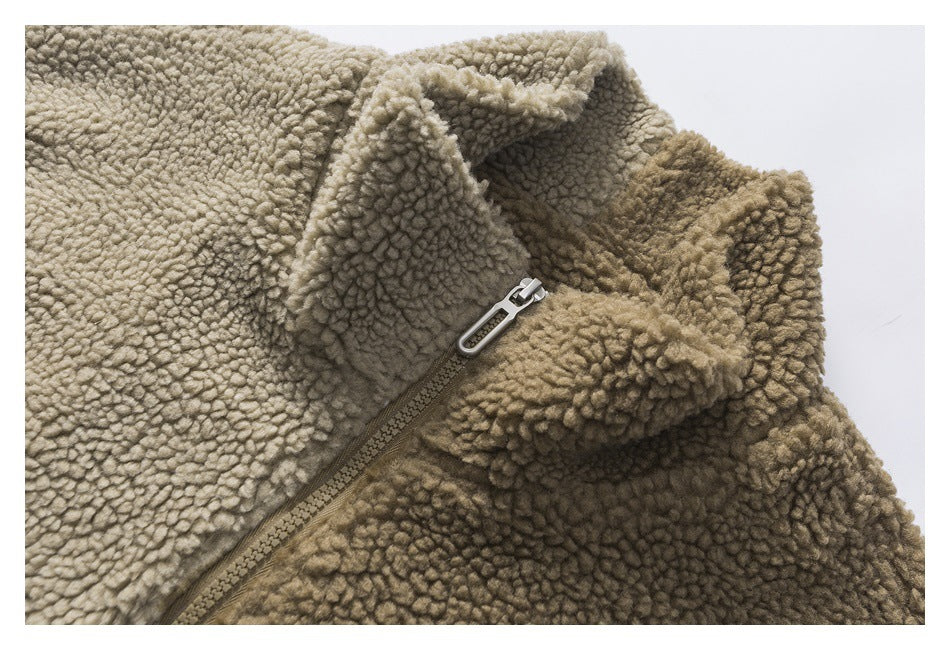 Close-up of the raised collar and zipper on a khaki textured fleece garment.