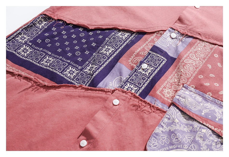 Close-up of a dusty rose button-up shirt with multicolored bandana-patterned panels and white buttons.