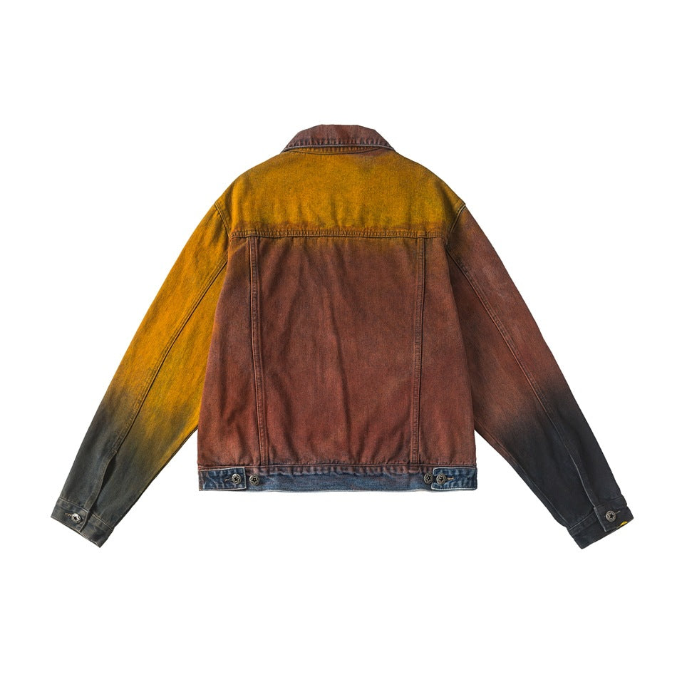 Back view of a color-block denim jacket with a rust body, mustard shoulder and sleeve panels, and dark cuffs.