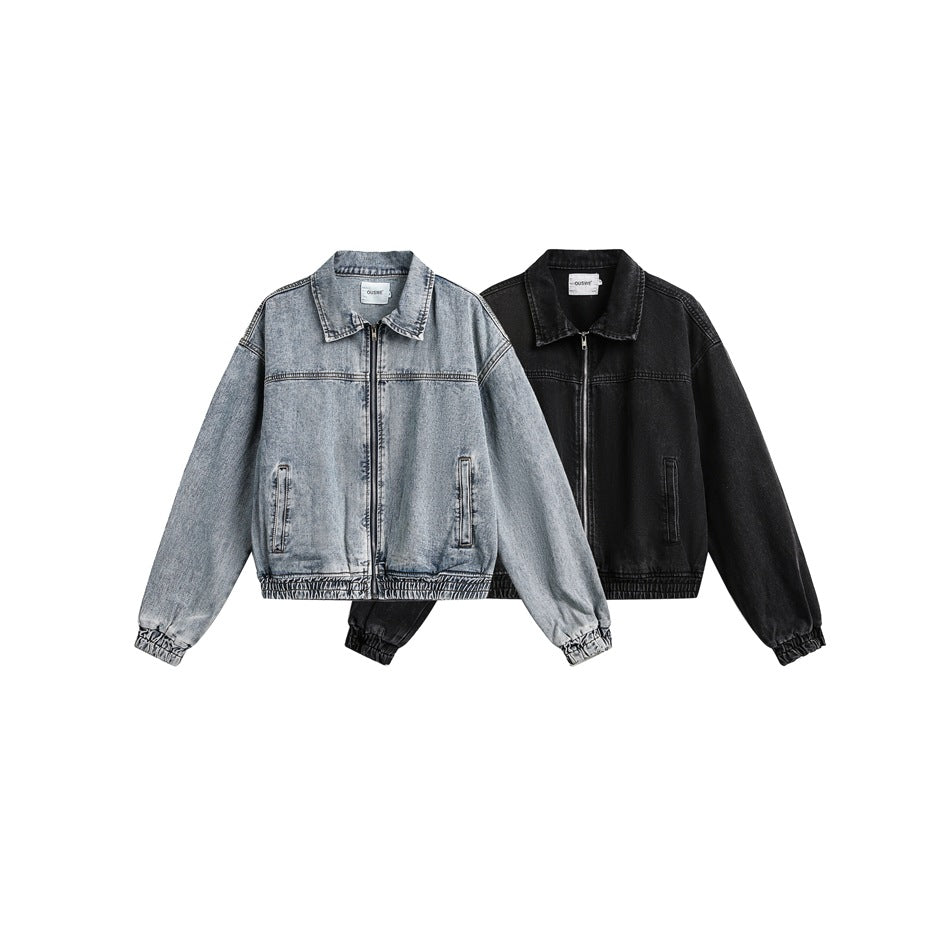 Two front-view zip jackets on white: one light-wash blue denim and one black, both with collars and elastic hems.
