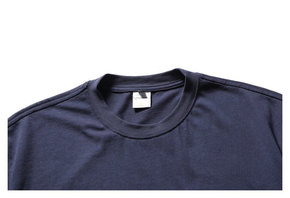 Close-up of the navy T-shirt's crew neck, shoulder seams, and small inner label.