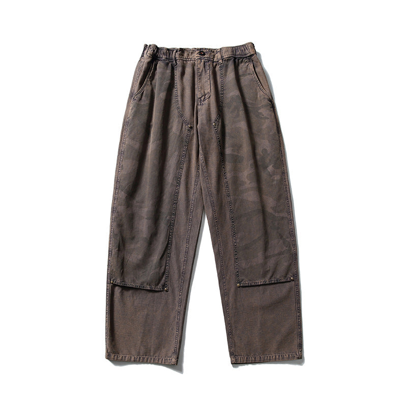 Gray brown washed wide-leg pants with tonal camouflage front leg panels and an elastic waist, flat lay