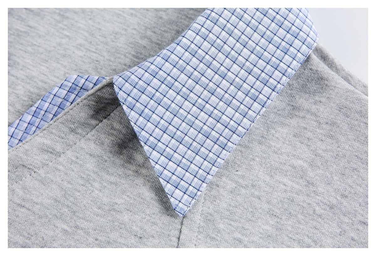 Close-up of a pointed blue checked collar against the light gray fabric of the top.
