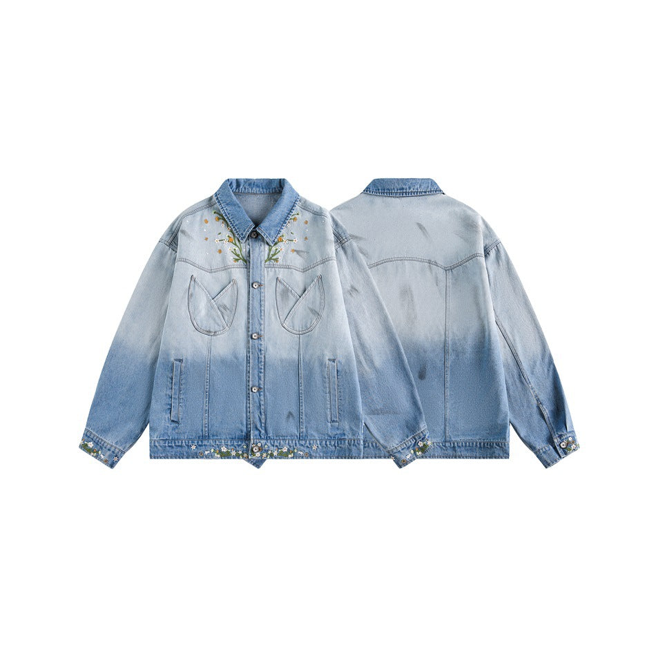 Light blue denim jacket shown from the front and back, with floral embroidery, large chest pockets and decorated cuffs and