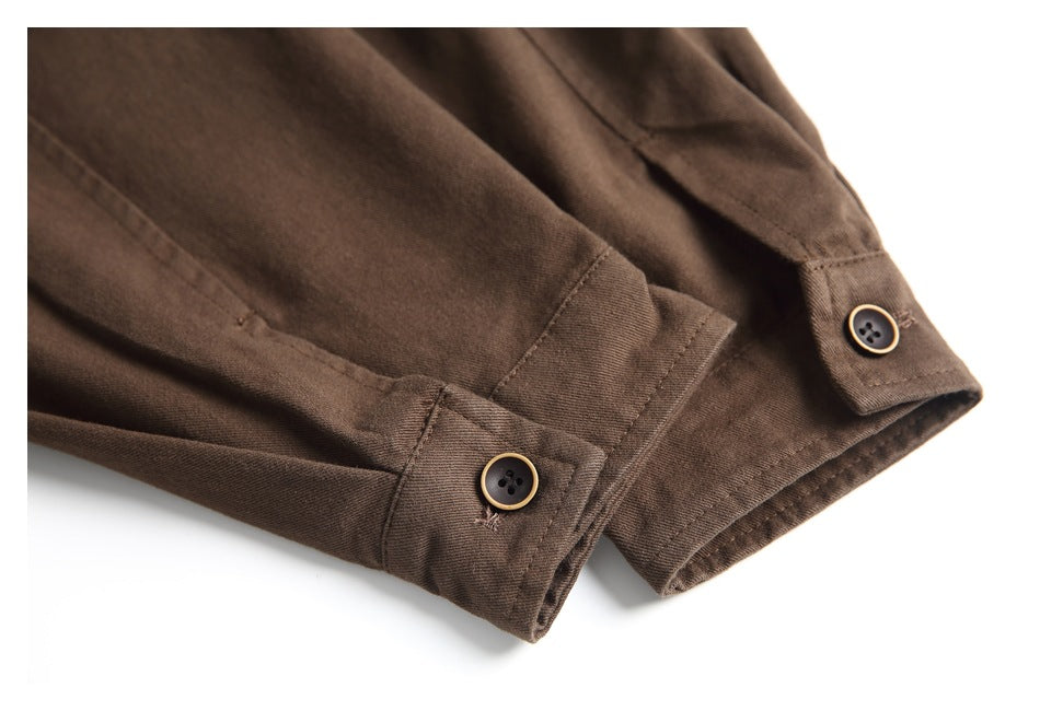 Close-up of brown garment cuffs with buttoned tabs and visible stitching on a white background.