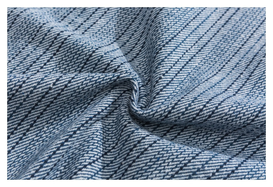 Close-up showing the blue-and-white woven pattern and texture of the garment fabric.