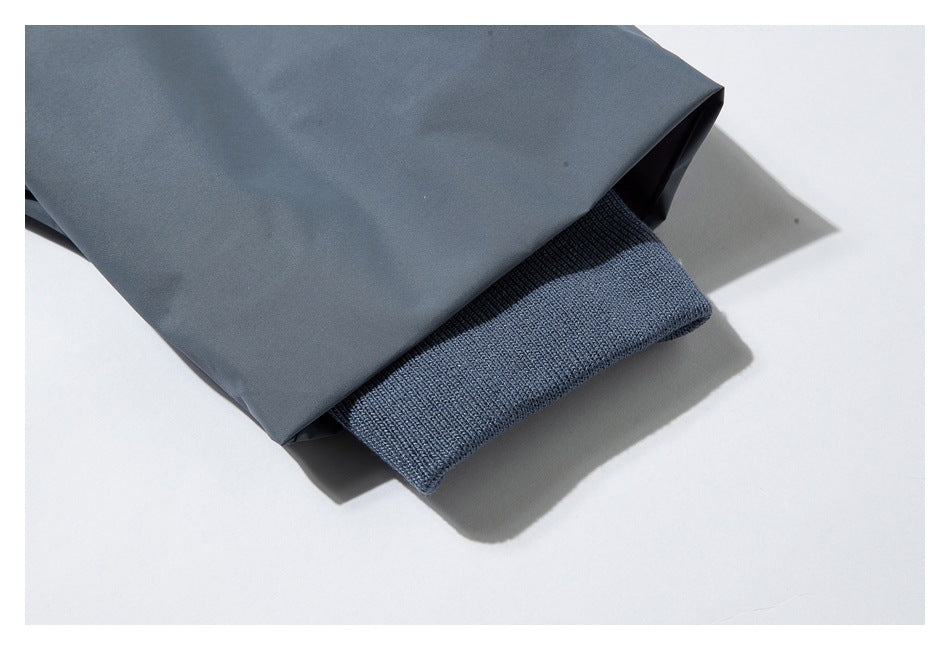 Gray-blue garment sleeve with a ribbed knit cuff visible at the opening.