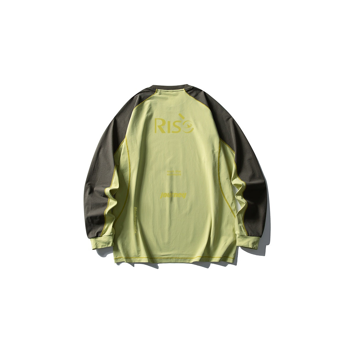 Back of a green long-sleeve raglan tee with dark olive sleeves, yellow contrast stitching and a RISE print