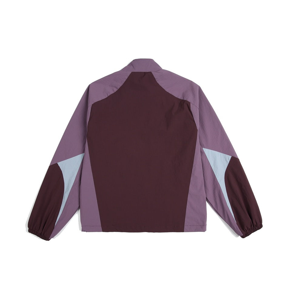 Back view of a color-block jacket in mauve, dark burgundy, and pale blue-gray, shown against a white background.