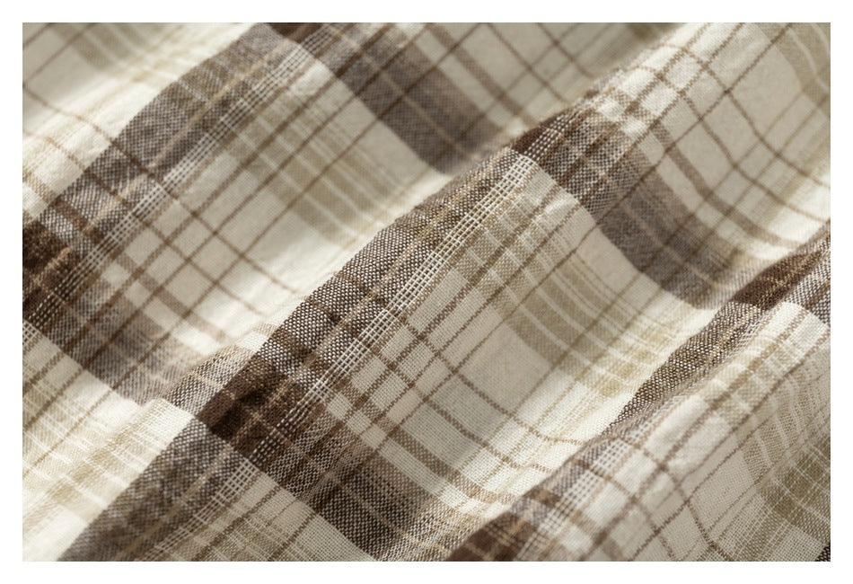 Close-up showing the woven texture and intersecting beige and brown checks of the fabric.