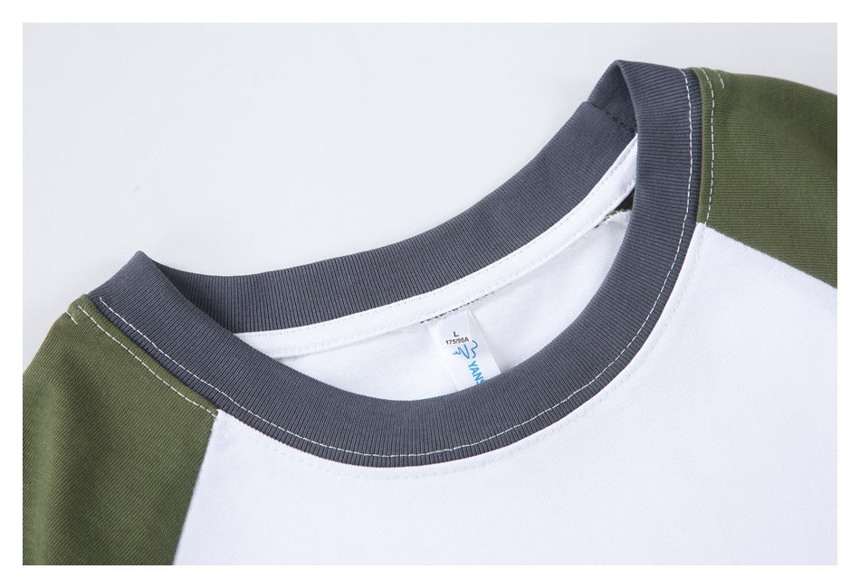 Close-up of the olive-and-white T-shirt neckline, showing a dark gray ribbed collar and contrast stitching.