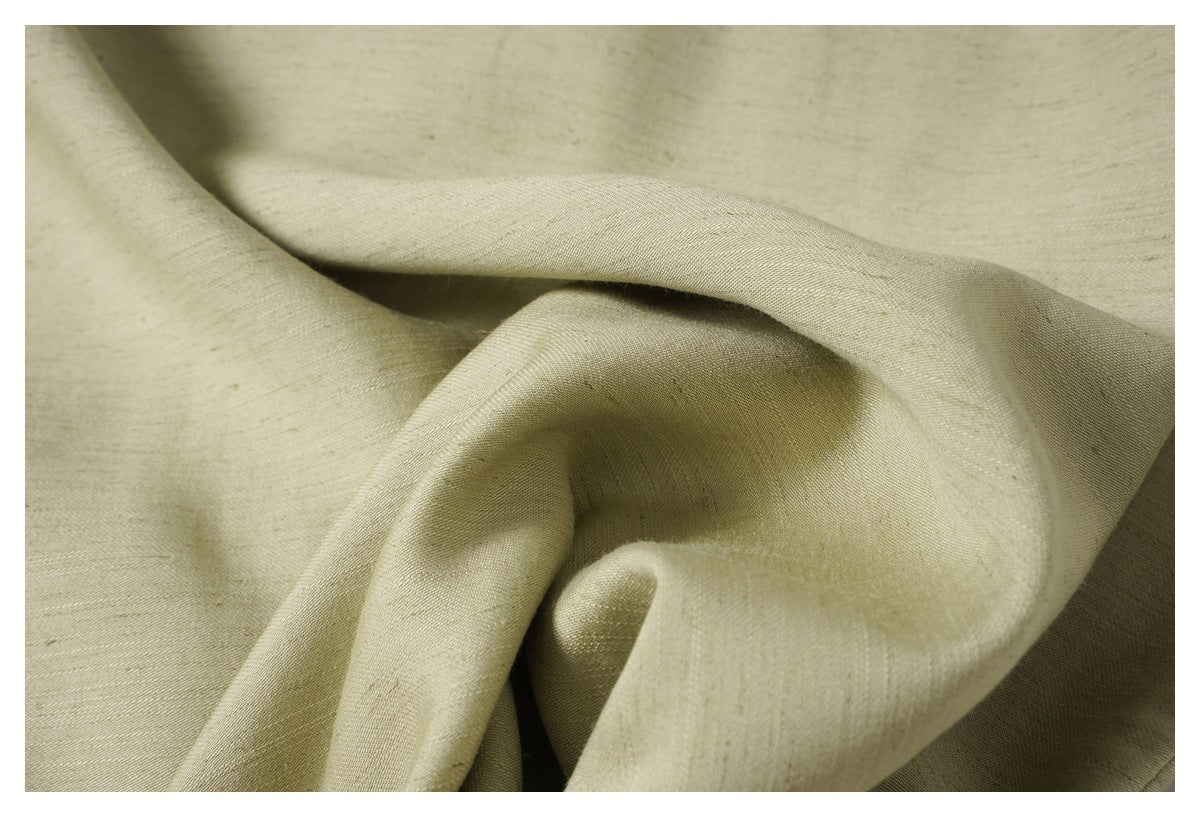 Close-up showing the draped texture and subtle slub-like surface of pale olive-beige fabric.