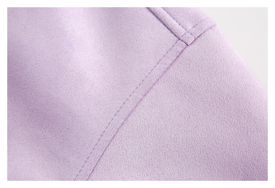 Close-up of a stitched seam on the lilac jacket.