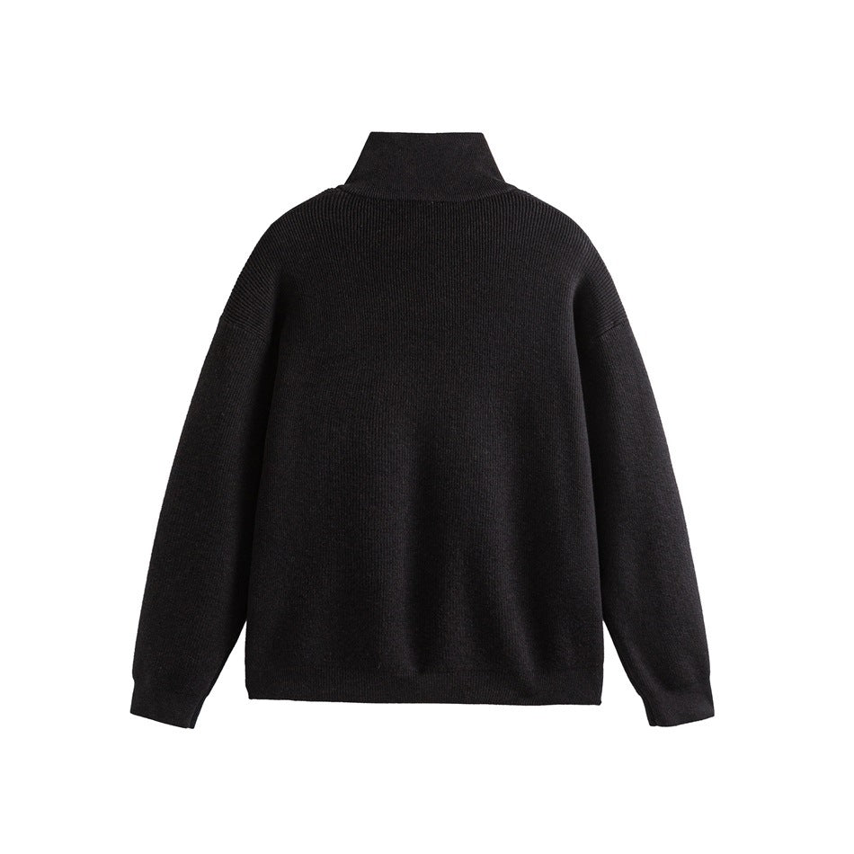 Back view of a black ribbed sweater with a high collar, long sleeves and ribbed hems.