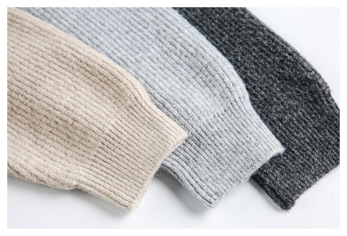 Close-up of ribbed cuffs on beige, light gray, and charcoal knit tops.