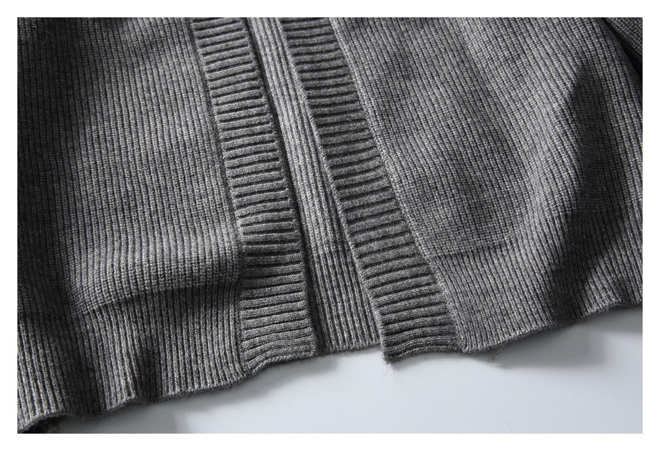 Close-up of the gray cardigan's ribbed front hem and wide vertical front bands.