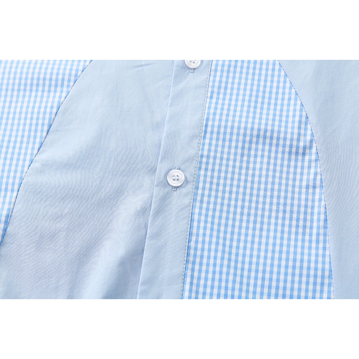 Close-up of the shirt front showing a pale blue placket, white buttons, and gingham side panels.