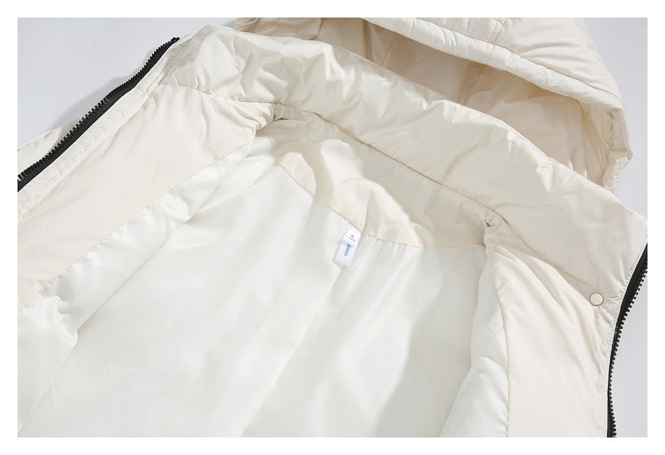 Open cream jacket showing its light lining, black zipper, snap fastener and a small interior tag.