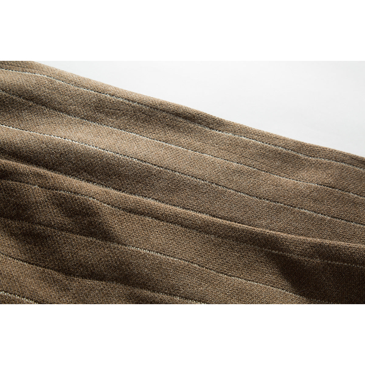 Close-up of brown knit fabric with narrow, lighter vertical stripes and visible seams.