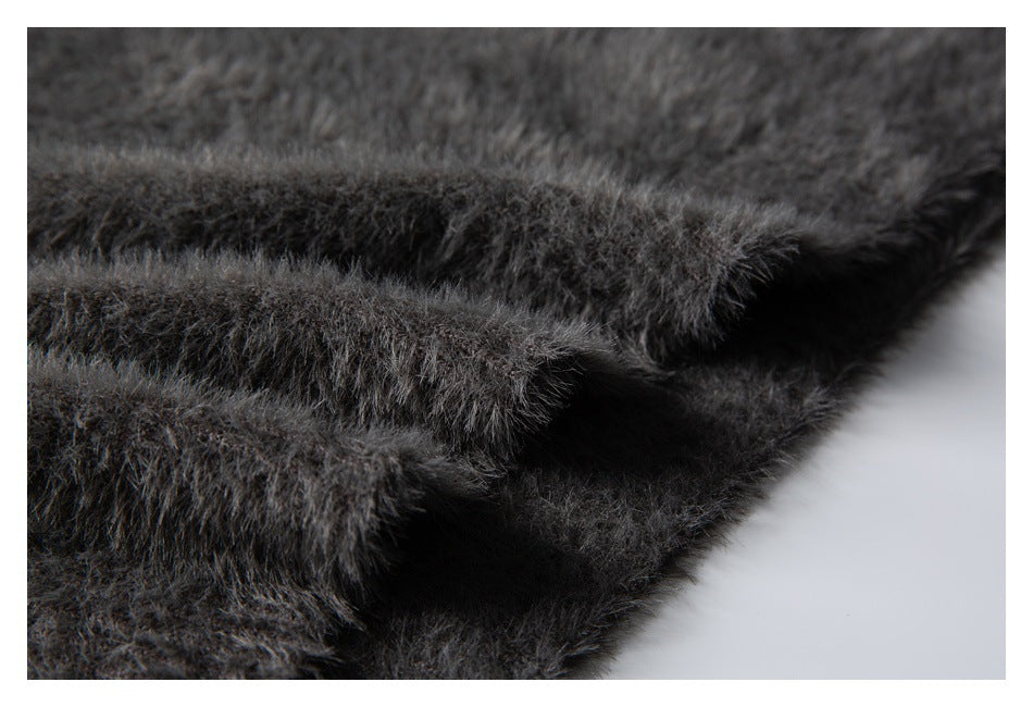 Close-up of layered, fuzzy charcoal gray knit edges and seams.