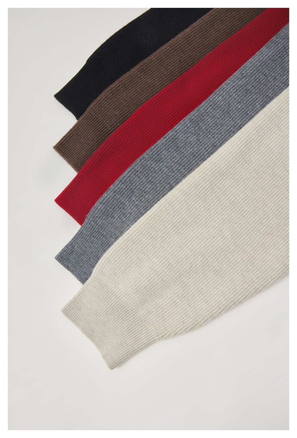 Rib-knit sweaters in black, brown, red, gray, and cream arranged diagonally in overlapping colorways.