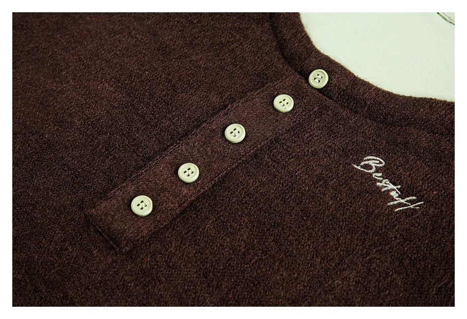 Dark brown fuzzy top detail with pale buttons and white cursive embroidery reading “Beautiful.”