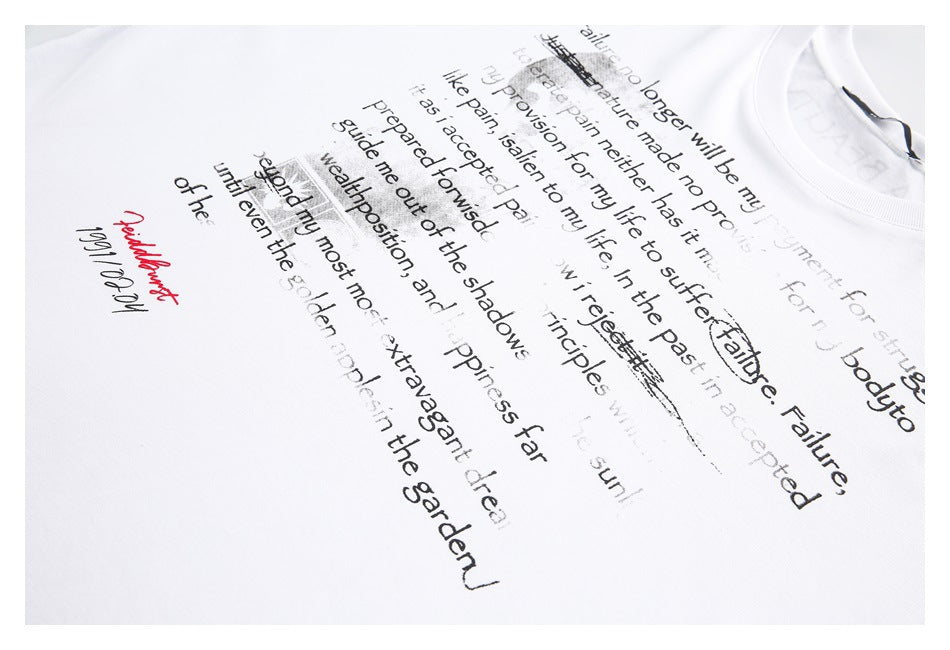 Angled close-up of an English text graphic printed on a white T-shirt.