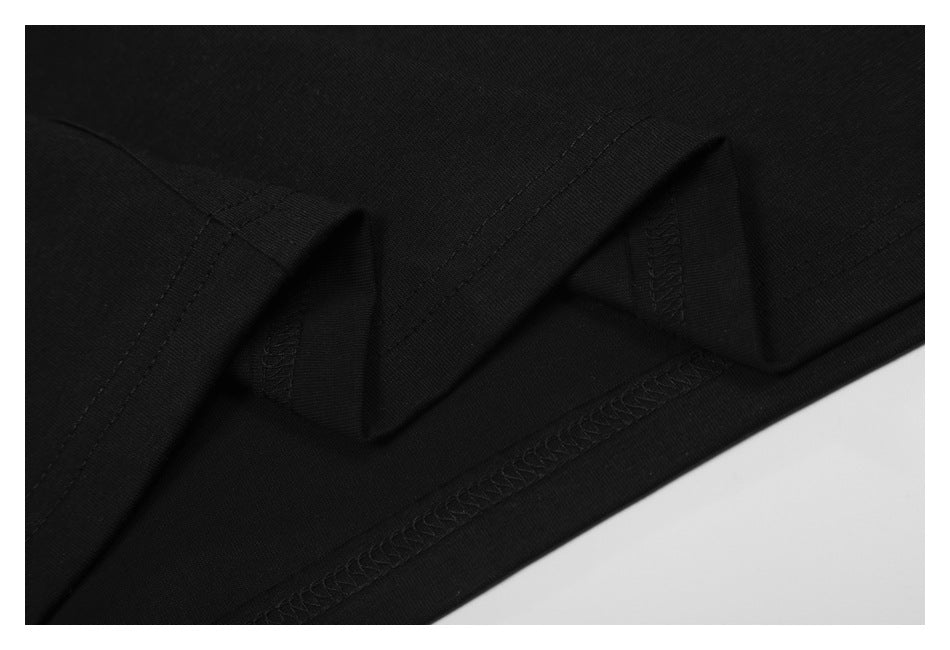 Close-up of black garment seams and overlock stitching along an edge.