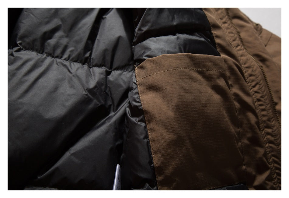 Inside detail of a brown jacket showing black lining and a brown interior pocket.