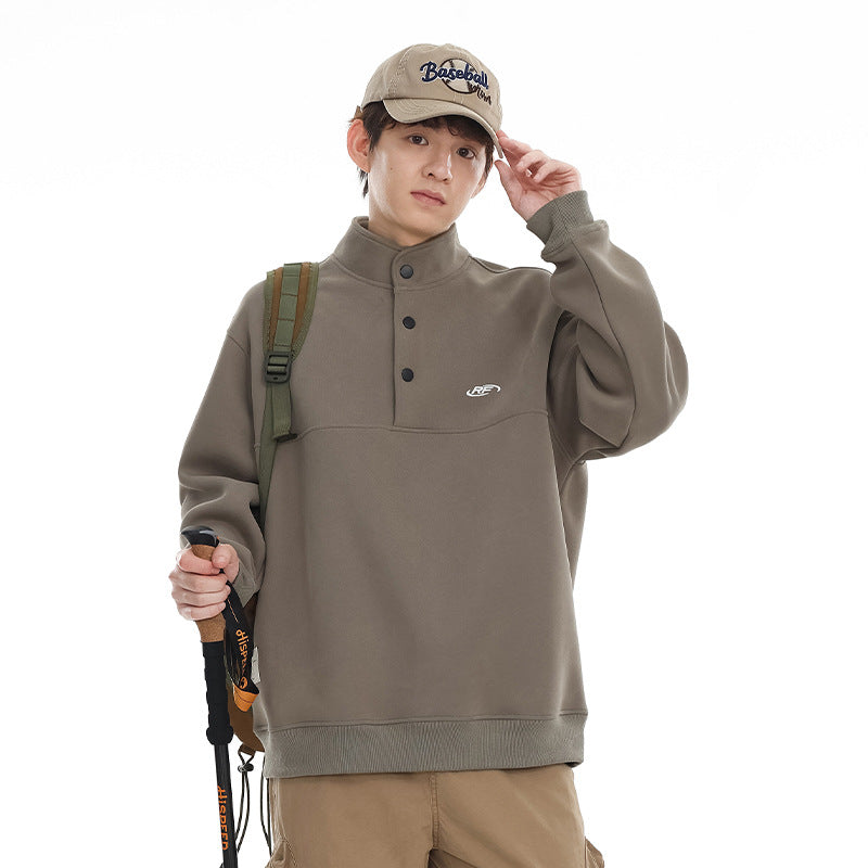 Model wearing a taupe button-neck pullover, shown from the front.