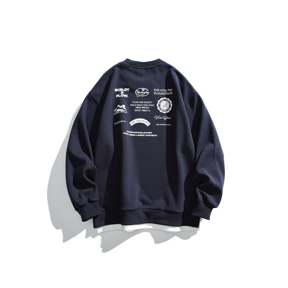 Back view of a navy crewneck sweatshirt with a cluster of white text and graphic prints across the upper back.