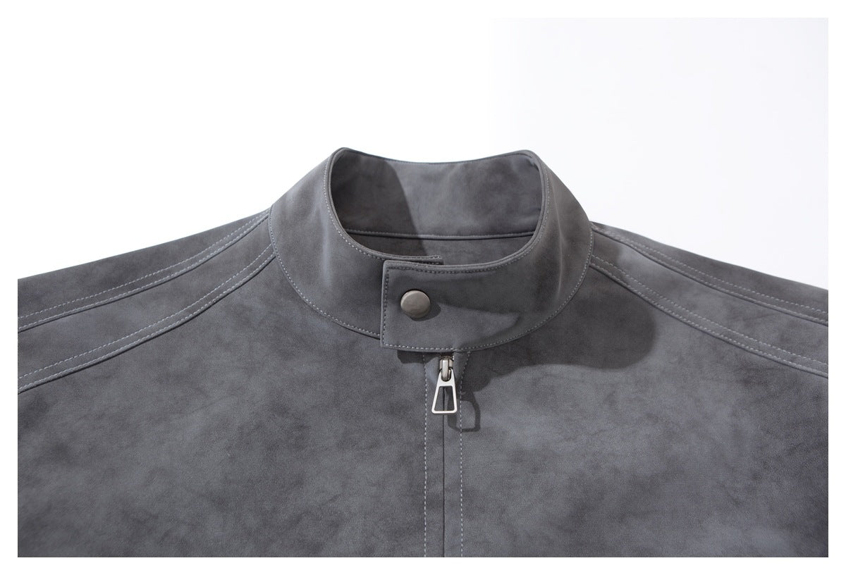 Close-up of the jacket's stand collar, snap tab, zipper pull, and stitched shoulder panels.