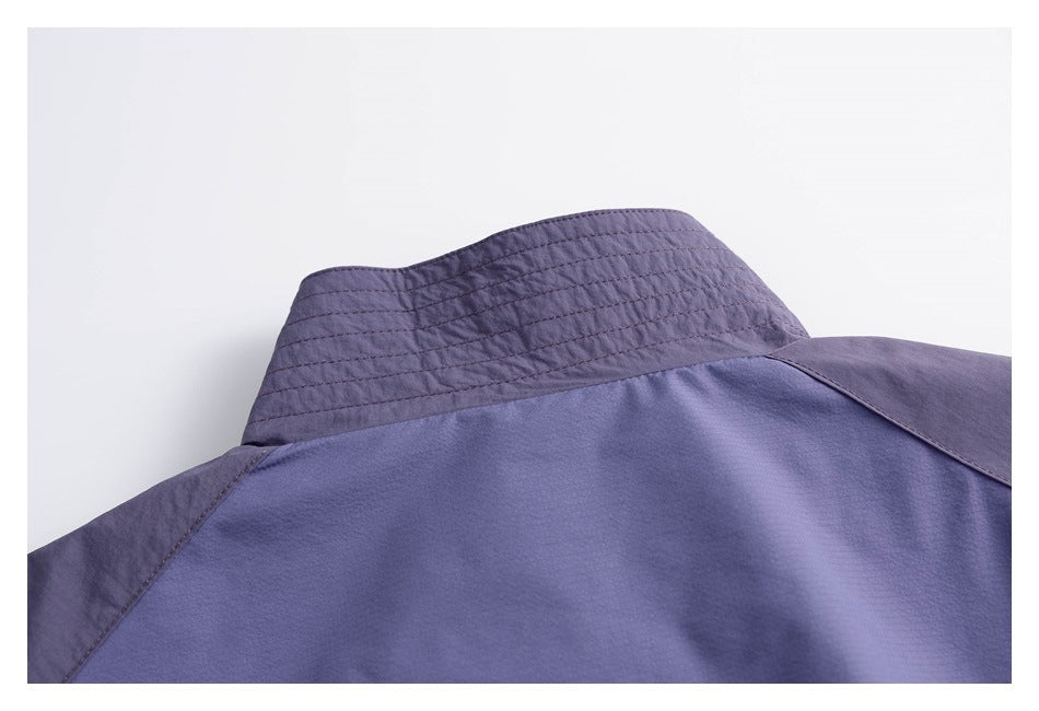 Close-up of a purple garment collar with horizontal stitching and a visible shoulder seam.