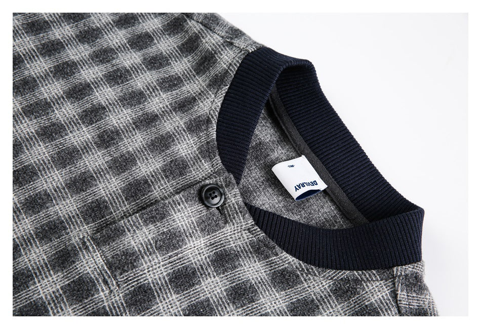 Close-up of the gray plaid jacket's navy ribbed neckline, black button, and white neck label.