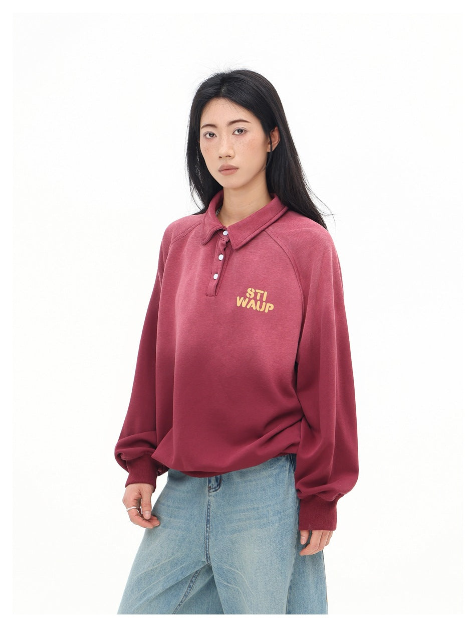Three-quarter front view of a model wearing a burgundy collared pullover with yellow chest lettering.
