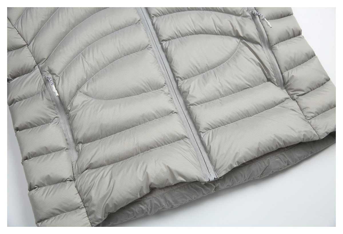 Partial front view of a light gray pinstriped puffer jacket with a center zipper and zippered pockets.