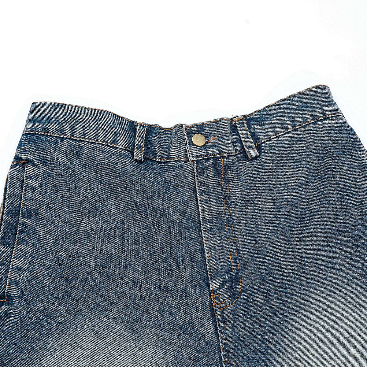 Close-up of blue jeans showing the waistband, brass button, belt loops, fly, and faded denim.