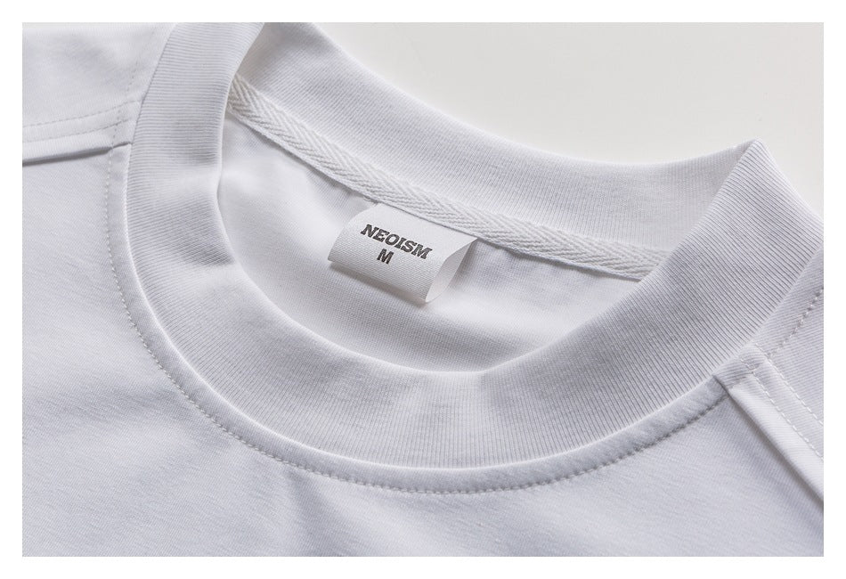 Close-up of a white T-shirt crew neck and inner label marked NEOTISM, size M.