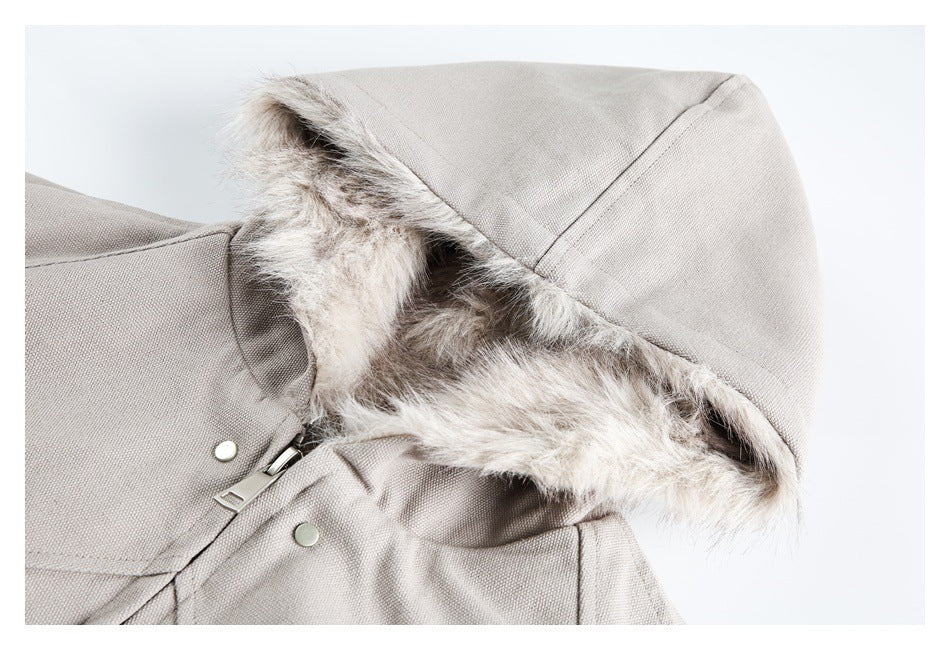 Close-up of a beige jacket hood with fluffy lining, zipper, and snap fasteners.
