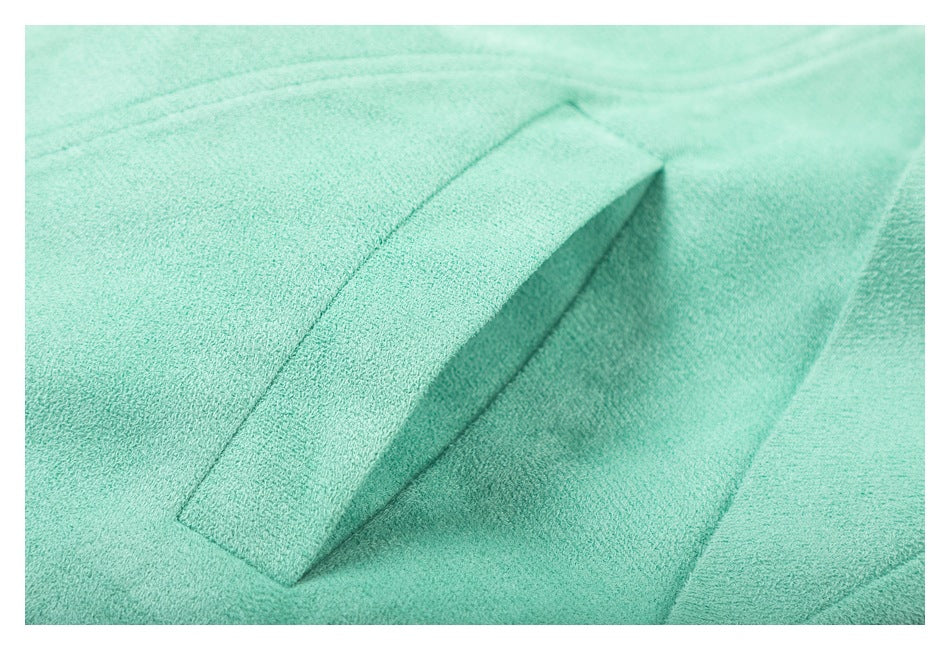 Close-up of a slanted pocket opening on the mint jacket.