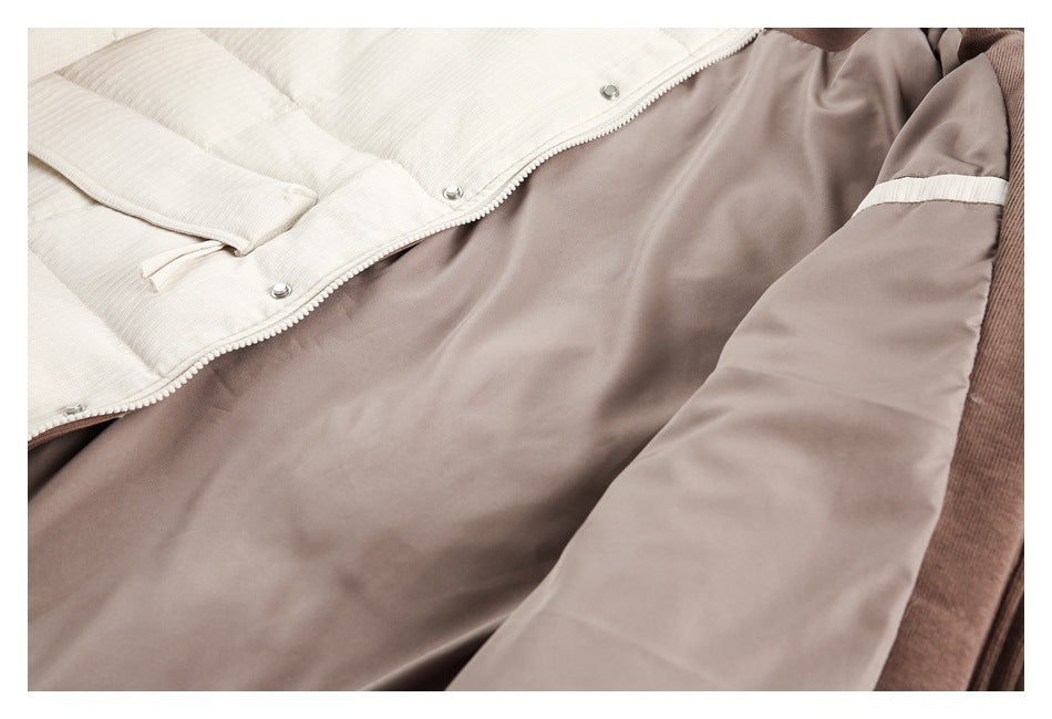 Close-up of an open ivory jacket showing its taupe lining, snap fasteners, and contrasting sleeve band.