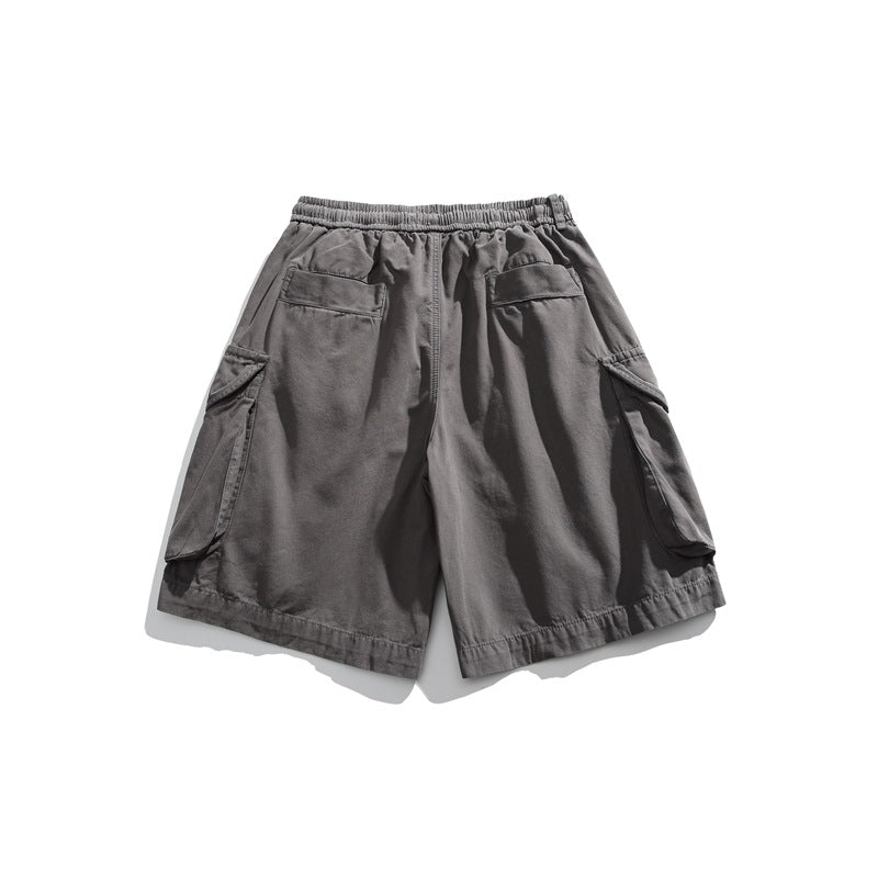 Back view of charcoal gray cargo shorts with an elastic waist, two rear pockets, and large flap cargo pockets.