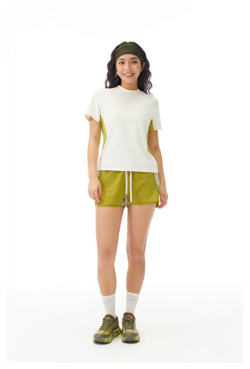 Full-length front view of a model in a cream T-shirt with lime side panels and matching lime shorts.