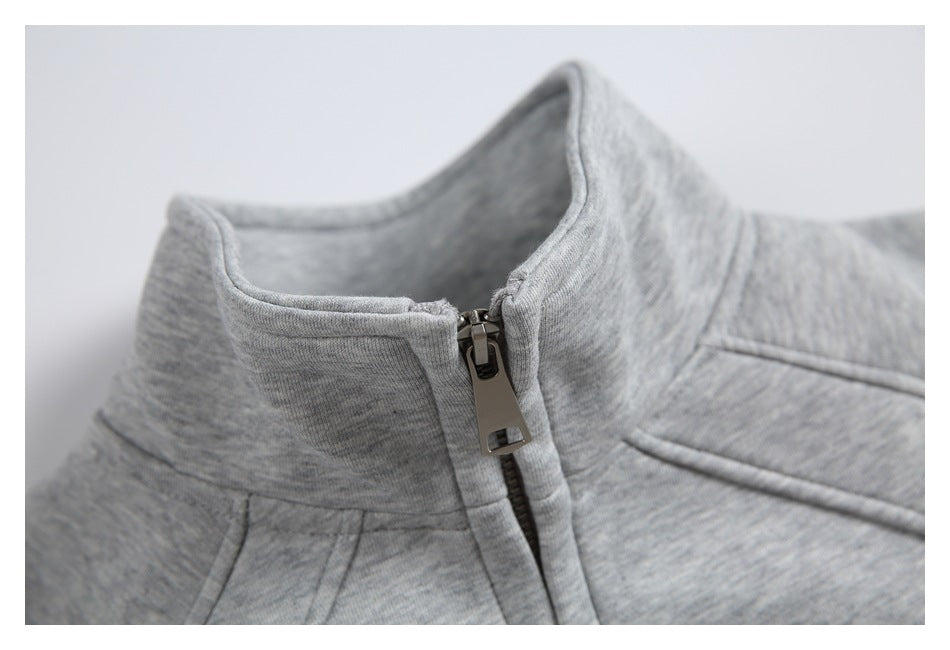 Close-up of the heather-gray jacket's raised collar and metal zipper pull.