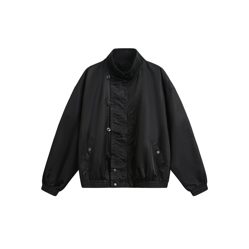 Black stand-collar bomber jacket flat lay with an asymmetric button front, snap-flap pockets and elastic cuffs