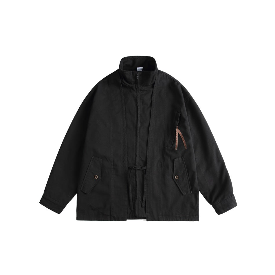 Black stand-collar zip jacket with waist tie, snap flap pockets and sleeve strap detail, flat front view