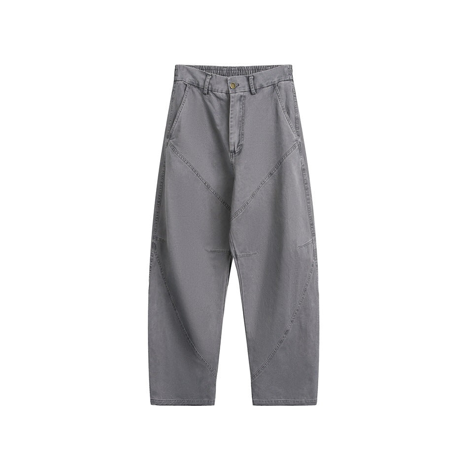 Gray wide-leg pants with diagonal paneled seams, button fly, belt loops and side pockets, flat front view