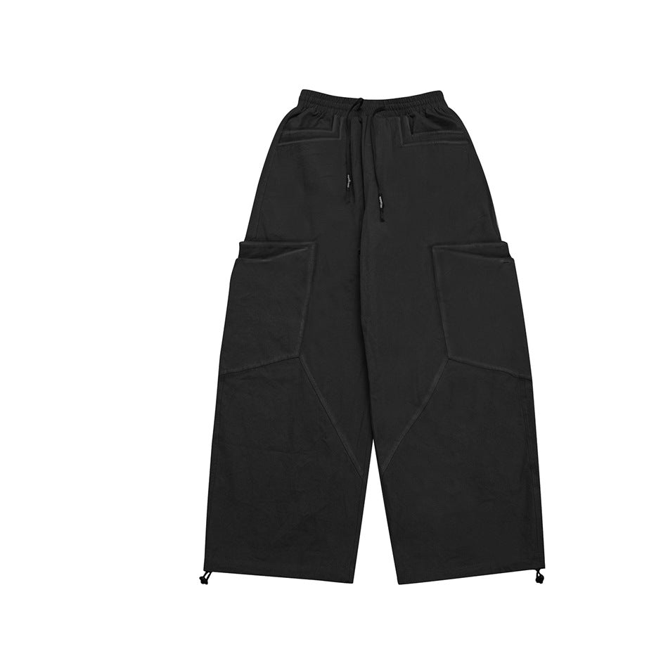 Black wide-leg cargo pants with drawstring waist, large side pockets and toggle hems, flat front view