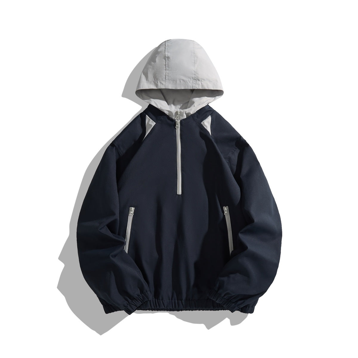 Navy half-zip hooded jacket with light gray hood, zipper trim and zip pockets, front flat view